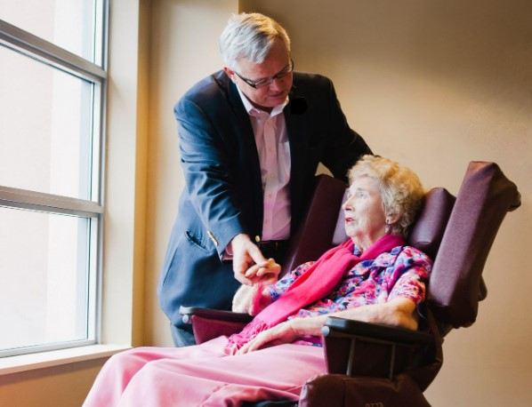 Bill talks with his mother in her Broda wheelchair