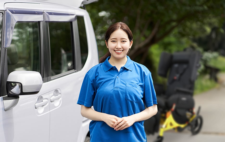 Young NEMT Operator standing in front of transportation