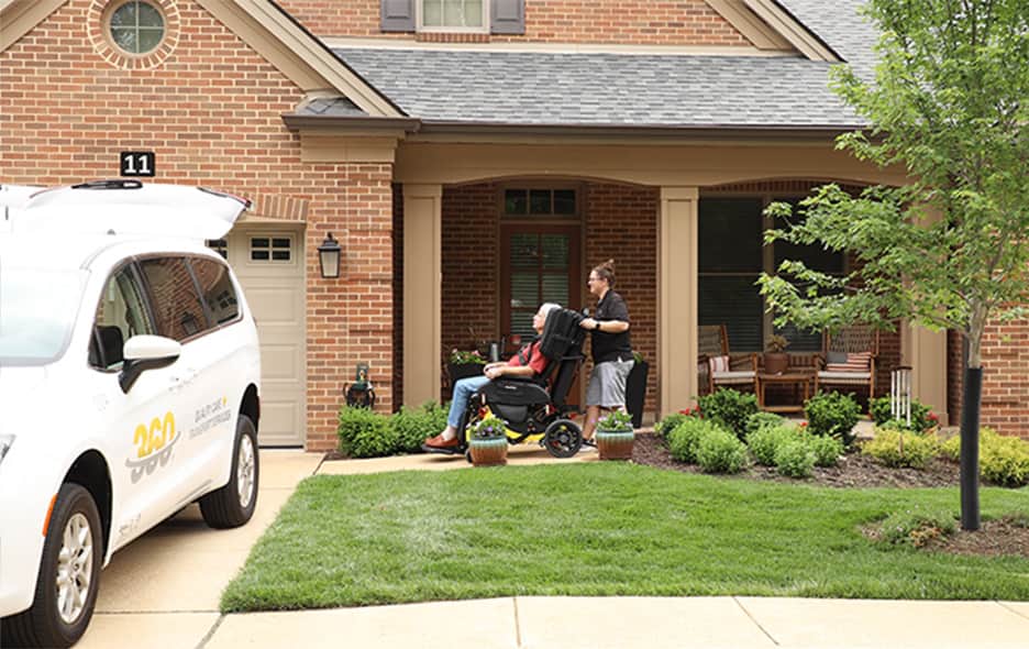 NEMT Operator and patient headed to a white van with a ramp