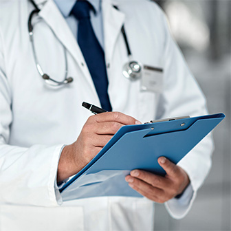 Doctor writing a note in patient file