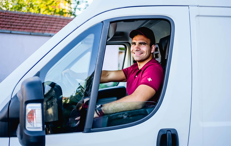 NEMT driver smiling from the driver's seat