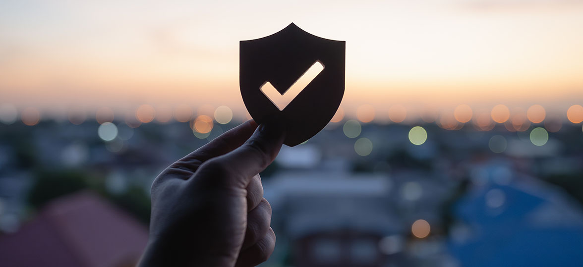 Silhouette of a shield with a cityscape background