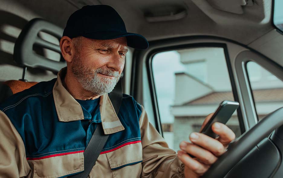 Transport driver, waiting and looking at his phone