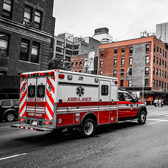 ambulance driving down a city street